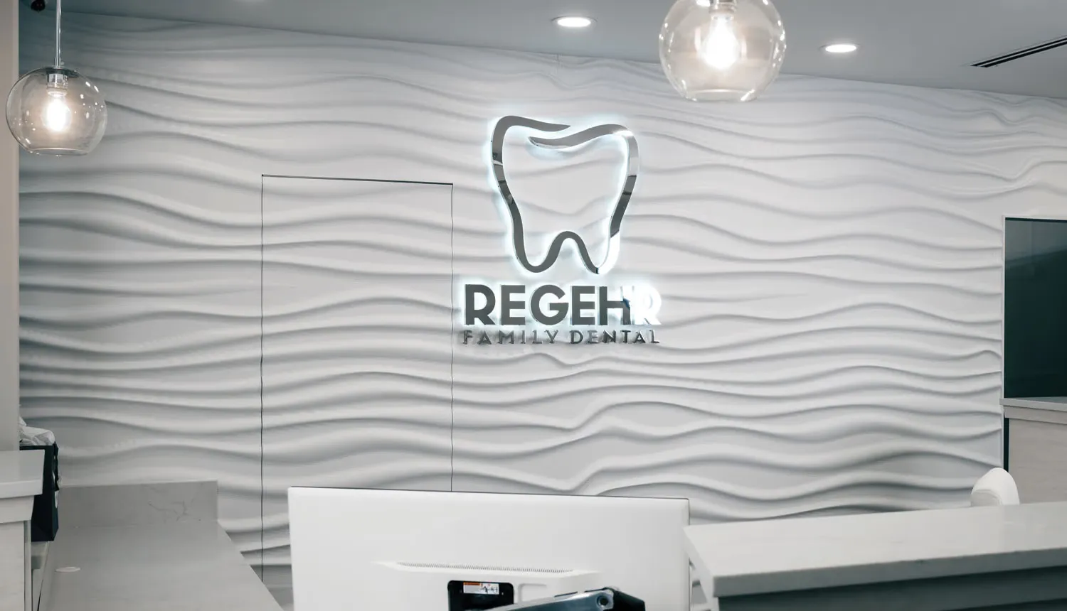 The Regehr Family Dental sign behind the front desk